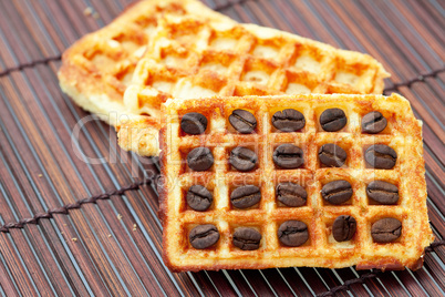 waffles and coffee beans on a bamboo mat