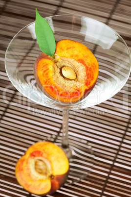 peach in the martini glass on a bamboo mat