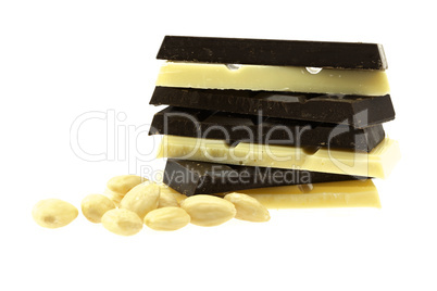 dark and white chocolate and nuts are isolated on white