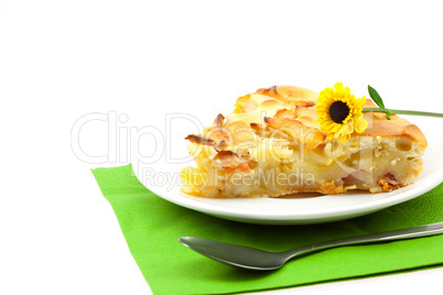 piece of apple pie and a flower lying on the green cloth