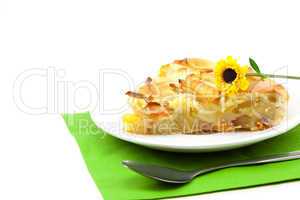 piece of apple pie and a flower lying on the green cloth