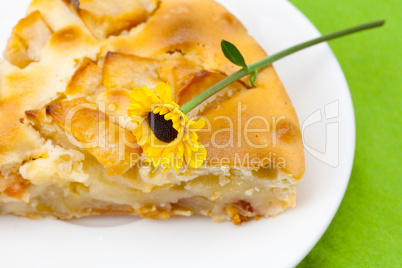 piece of apple pie and a flower lying on the green cloth