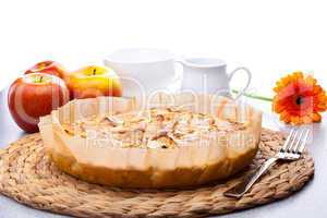 still life of apple pie, apple Gerbera milk jug and a cup