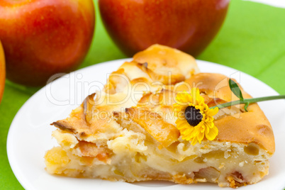 piece of apple pie and a flower lying on the green cloth