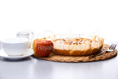 still life of apple pie, apple Gerbera milk jug and a cup