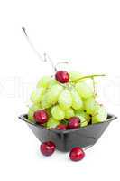 grapes cherry and spoon  in the bowl is isolated on white