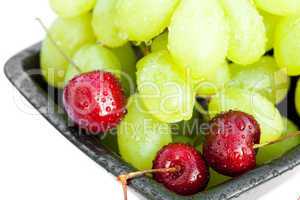 grapes cherry in the bowl is isolated on white
