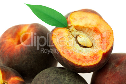ripe peaches with green leaf isolated on white