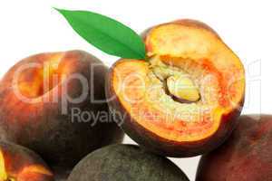ripe peaches with green leaf isolated on white
