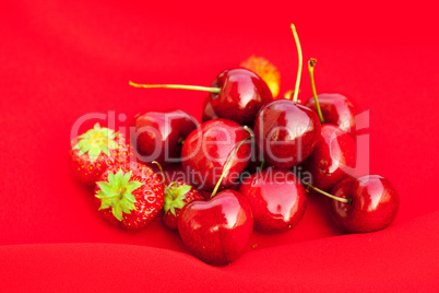 cherry and strawberry on a red background