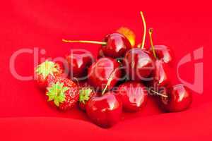 cherry and strawberry on a red background