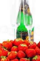 bottle of champagne, wine glass, a plate of strawberries isolate