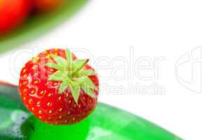 bottle of champagne with strawberries isolated on white