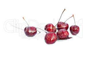 cherries lying in the spoon isolated on white