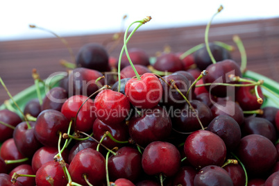 cherry in plate on a bamboo mat