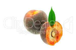peaches with green leaf isolated on white