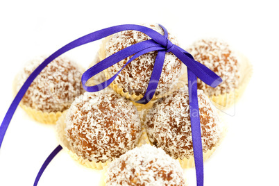 cake with coconut tied with ribbon isolated on white