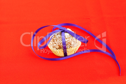 coconut cake with a ribbon tied on a red background