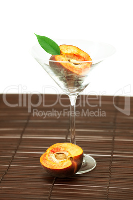 peach in the martini glass on a bamboo mat