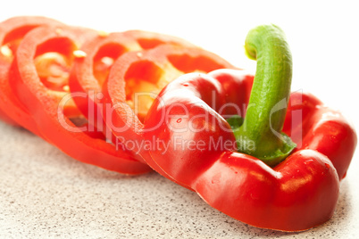 chopped red pepper with drops of water on the table