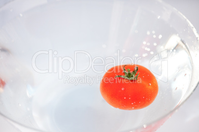 tomatoes with splashes of water in a glass bowl