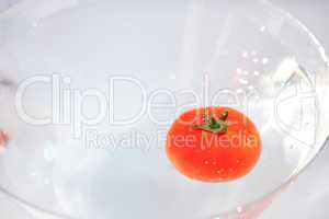 tomatoes with splashes of water in a glass bowl