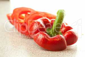 chopped red pepper with drops of water on the table