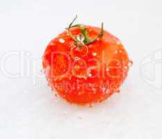 tomatoes with splashes of water isolated on white