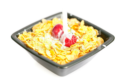 strawberries and cherries in the bowl of Cornflakes with milk is