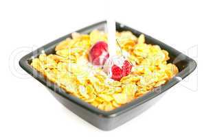 strawberries and cherries in the bowl of Cornflakes with milk is
