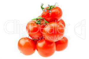 tomato with eyes lying on a pile of tomato isolated on white