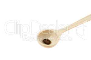 wooden spoon with coffee beans isolated on white