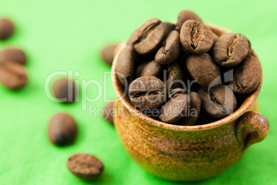 small pot of coffee beans on the green matter