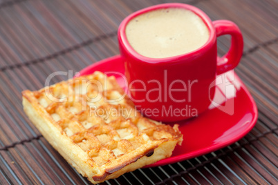 waffles and cappuccino on a bamboo mat