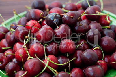 cherries in a dish on a bamboo mat