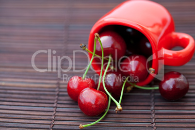 cherry in the cup on a bamboo mat