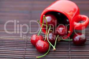 cherry in the cup on a bamboo mat
