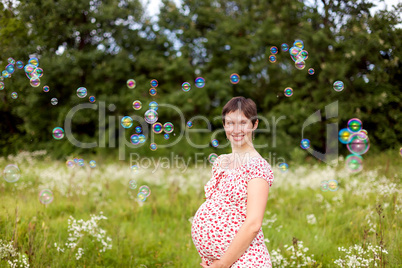 Pregnant woman with soap bubbles