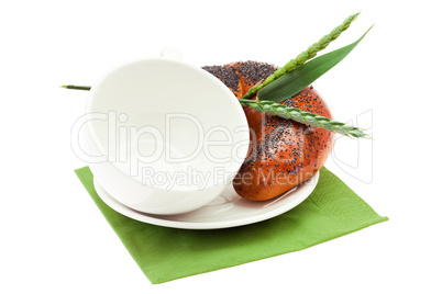 bread with poppy seeds, a cup and spike isolated on white