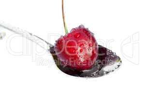 cherry in spoon isolated on white