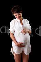 Pregnant young woman in a white shirt