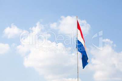 Dutch flag against the blue sky