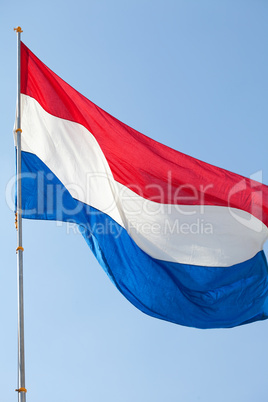 Dutch flag against the blue sky