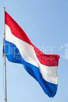 Dutch flag against the blue sky