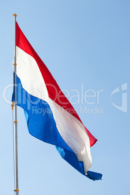 Dutch flag against the blue sky