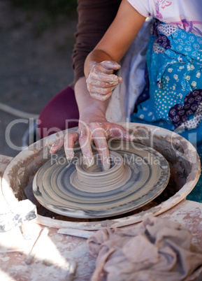woman and child in a potter's wheel