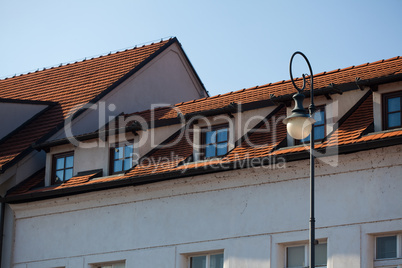 The roof, windows, lights against the sky