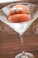 Peach with eyes in the glass martini on a bamboo mat
