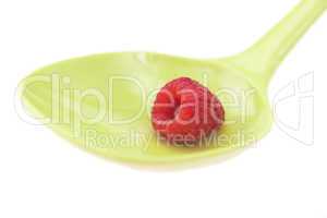 Raspberries in a spoon isolated on white