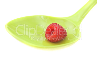 Raspberries in a spoon isolated on white